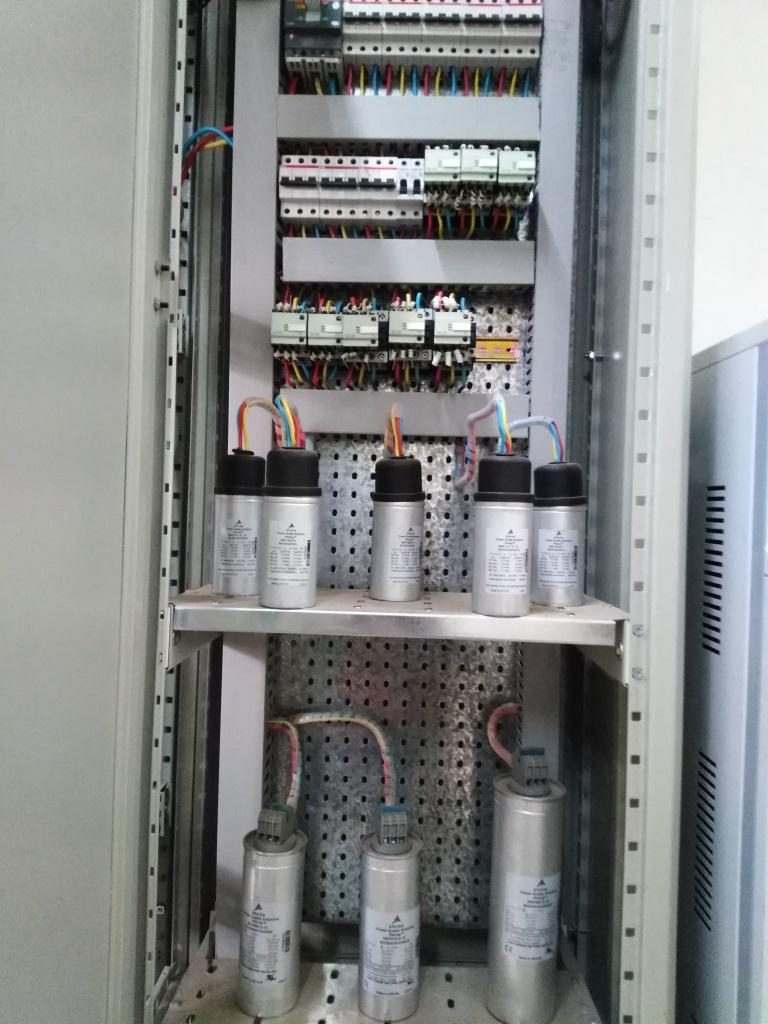 Power factor correction capacitor bank installed in a switchboard